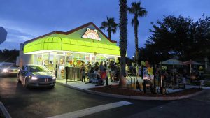 Free standing Jeremiah's Italian Ice and ice cream franchise location packed with people.