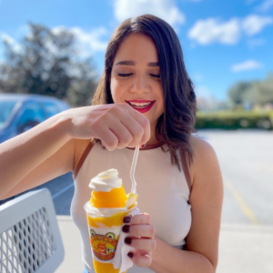 Jeremiah's Franchisees love frozen dessert franchising because people, like this woman, love our product. She's smiling while she eats a delicious Jeremiah's Gelati!