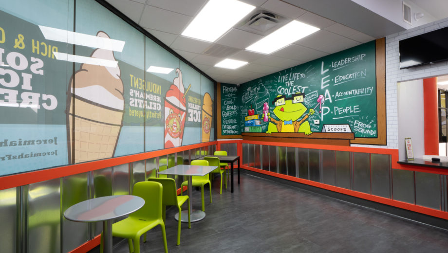 Photo of Jeremiah’s Italian Ice store interior with green chairs and tables
