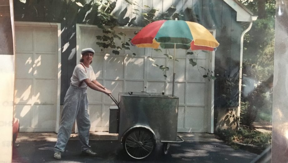 Old photo of a boy with a pushcart.